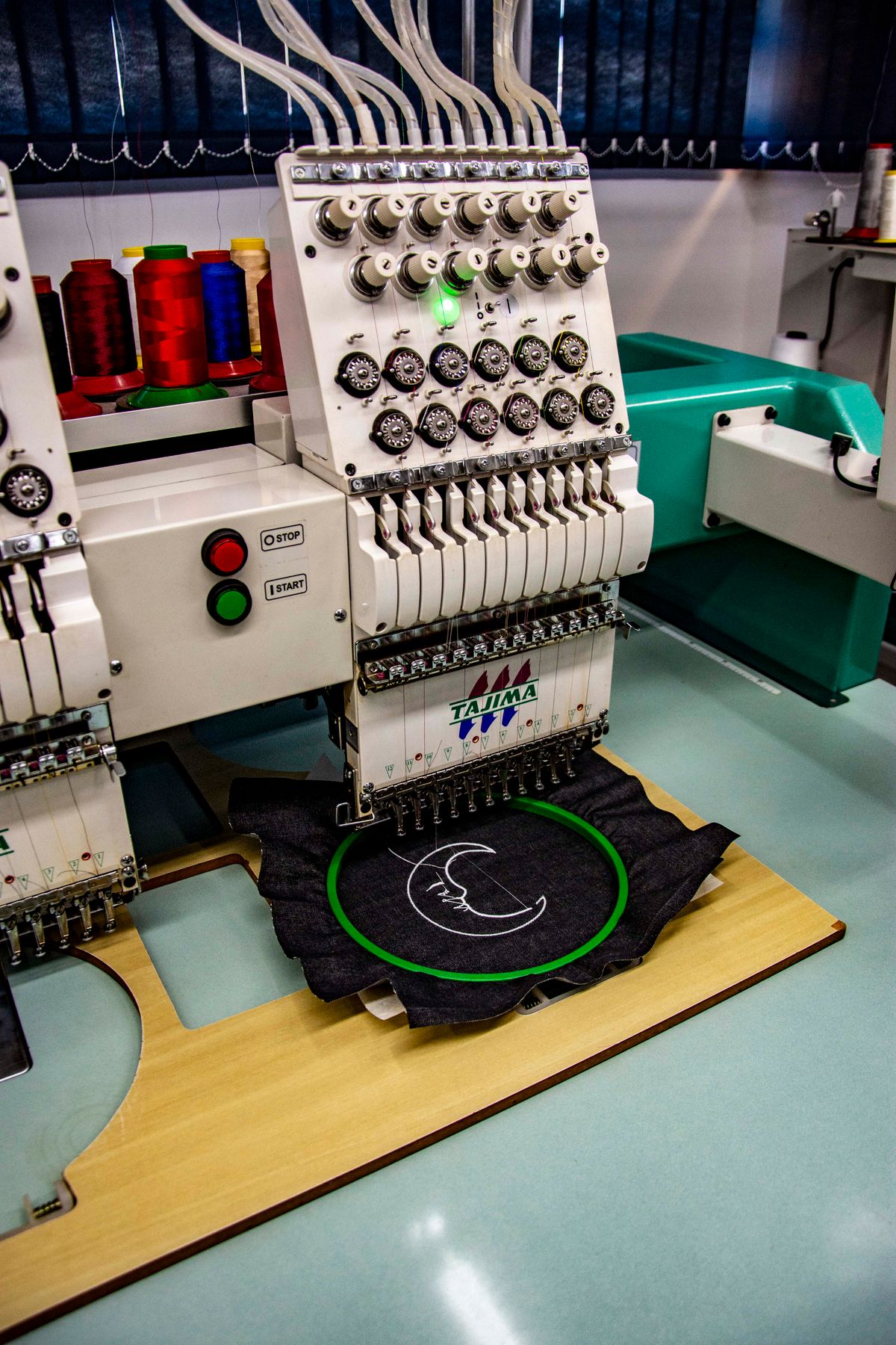 Industrial embroidery machine stitching a logo
