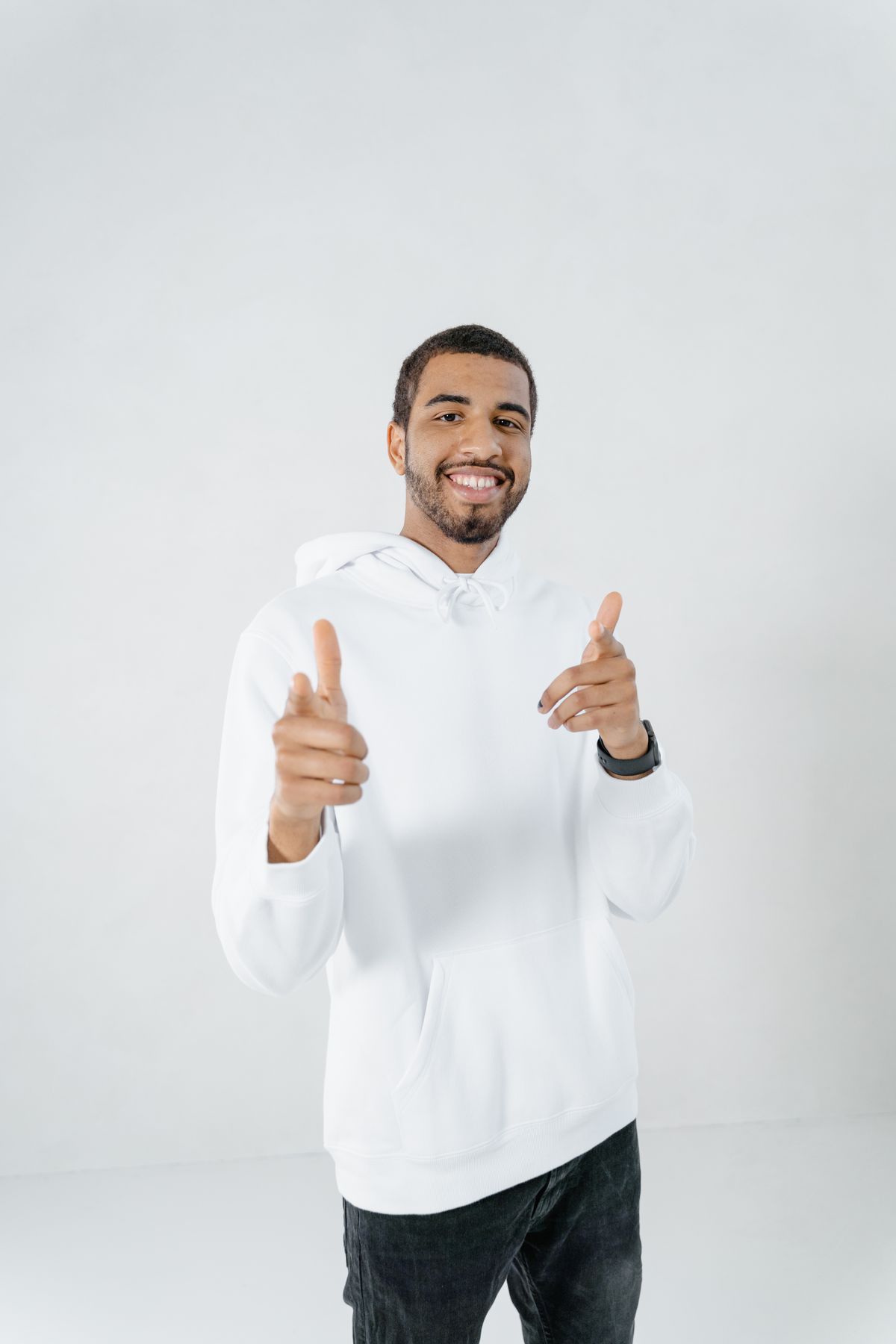Smiling man wearing a white hoodie