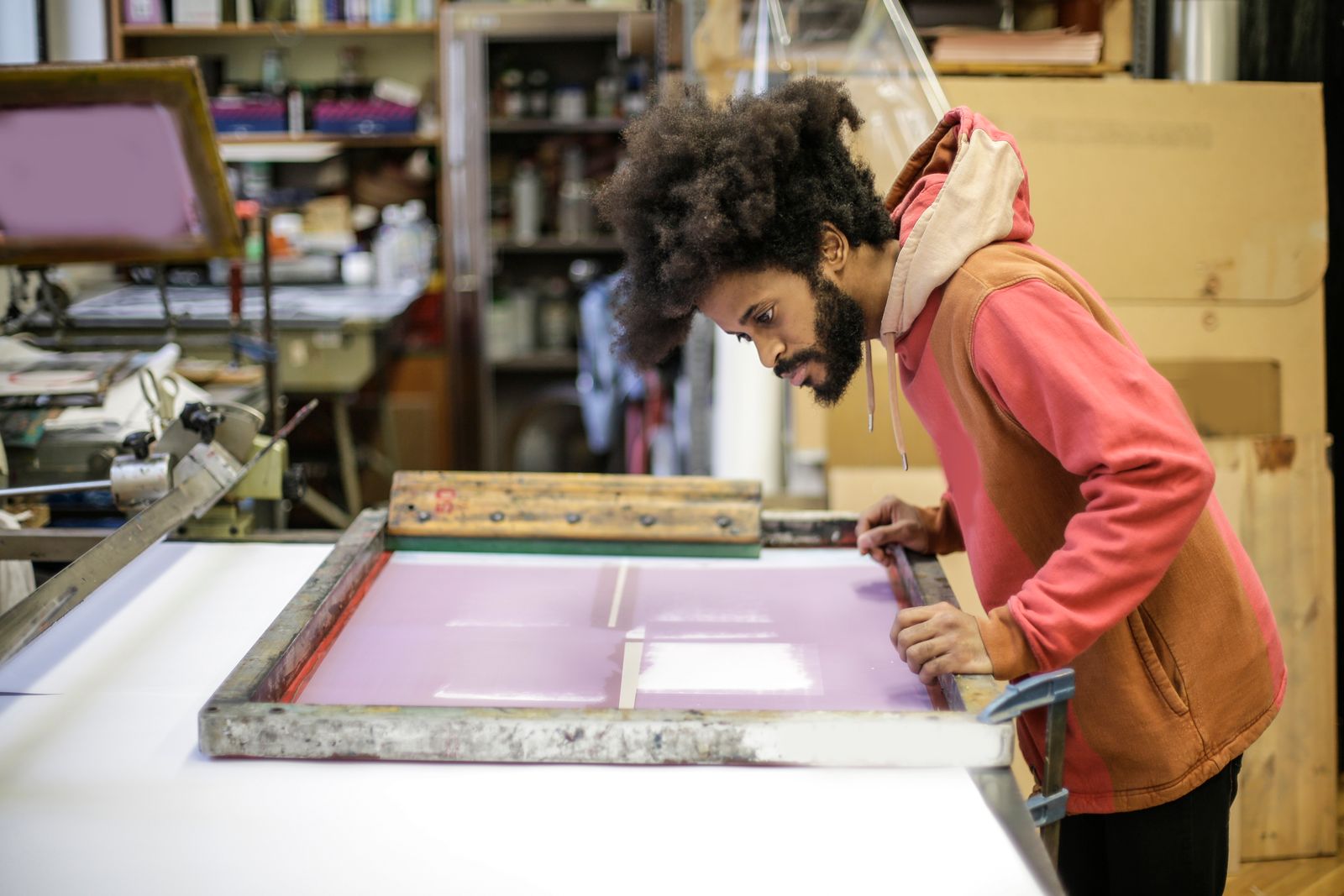 Craftsman preparing a screen print in a studio