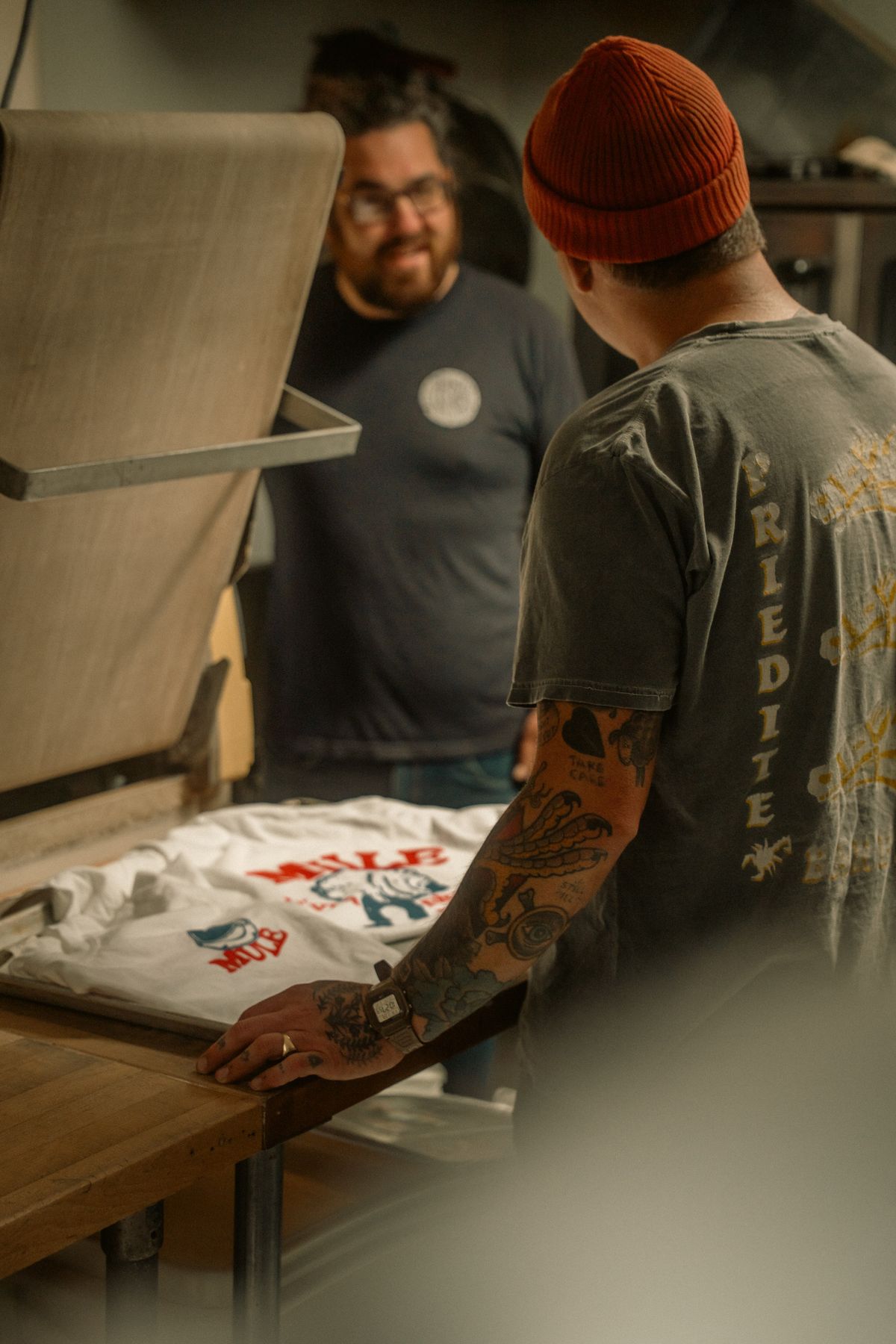 Printers producing t-shirts in a print workshop